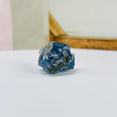 blue fluorite with decorations in the background