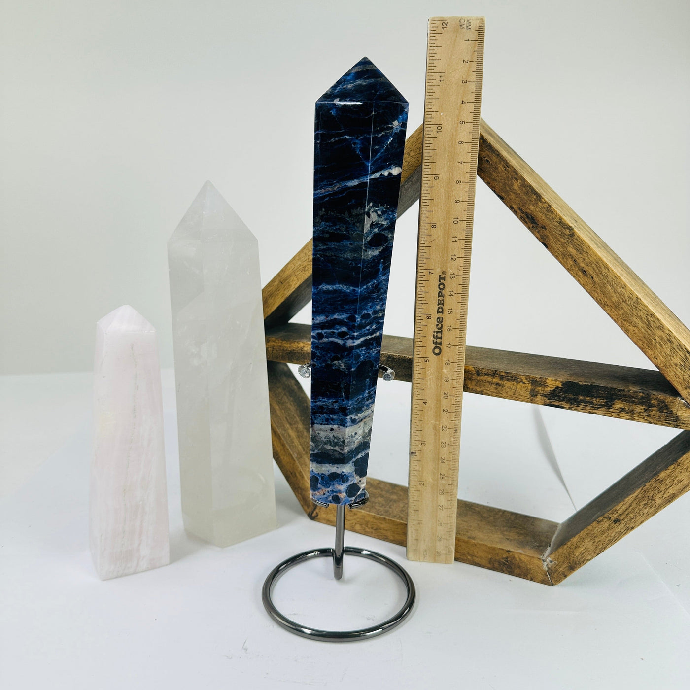 sodalite point next to a ruler for size reference