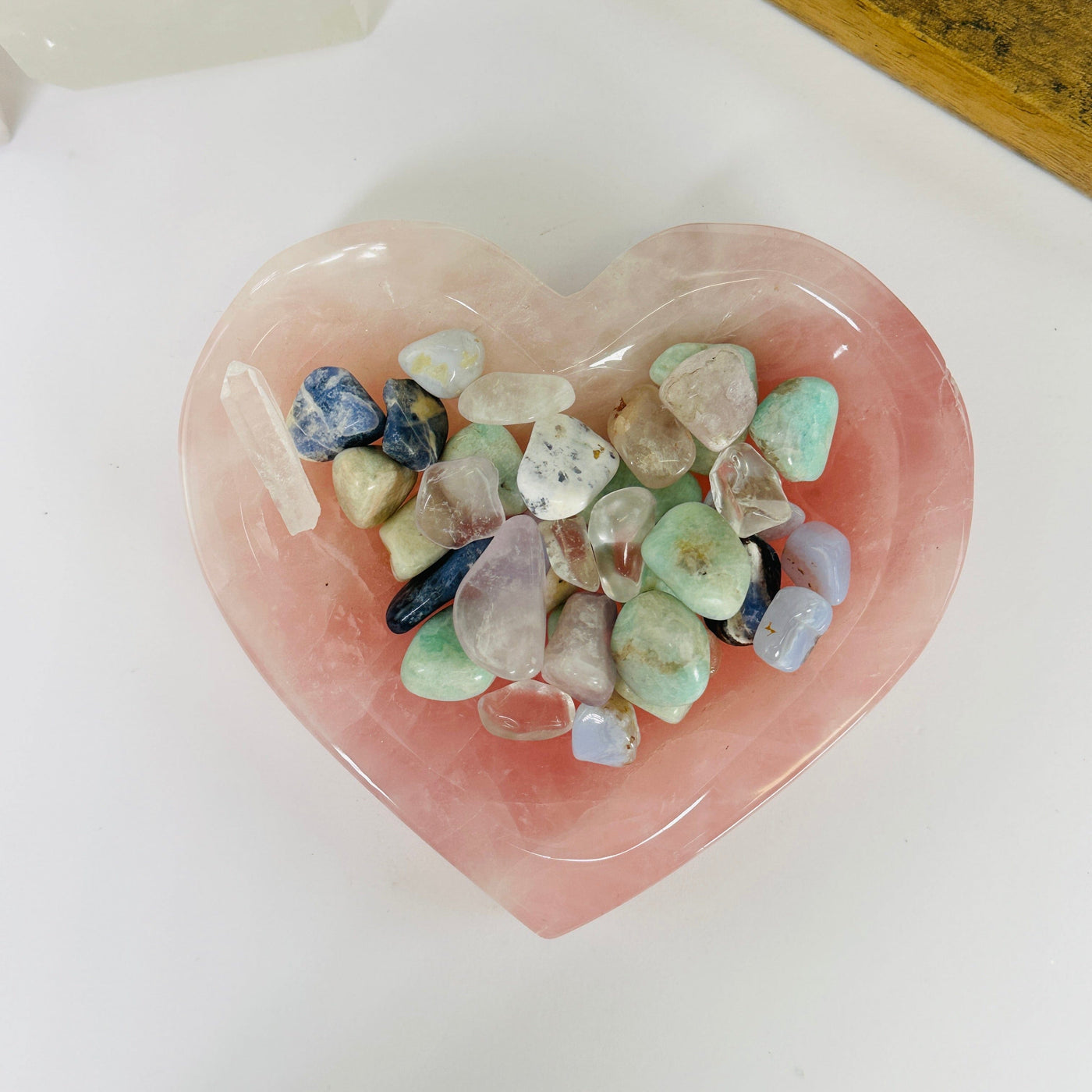 rose quartz heart bowl with decorations in the background