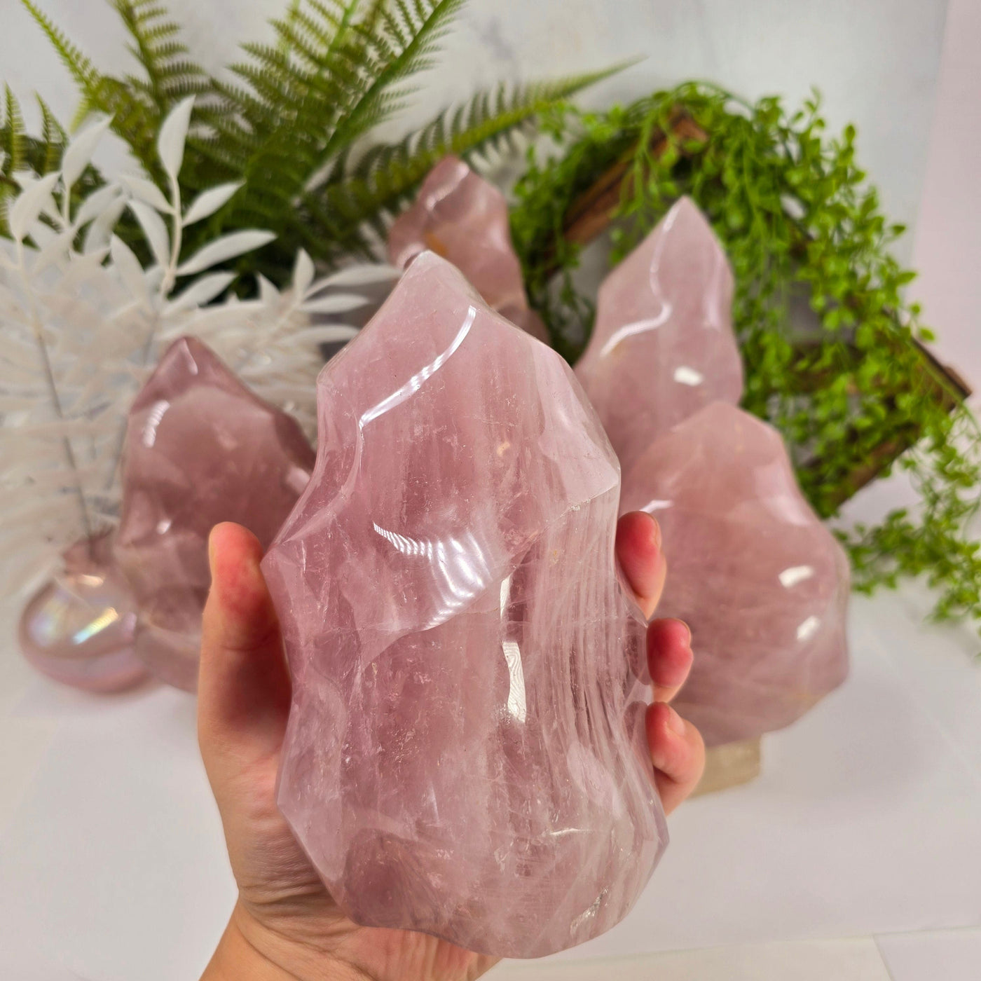  Rose Quartz Flame Tower - Carved Polished Crystal - You Choose variant B in hand with other variants in the background for size reference