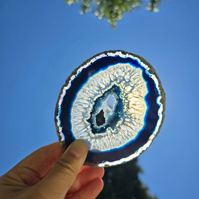 Agate Slice Set - Set of Six Blue Agate Crystal Coasters slice 3 backlit by sun