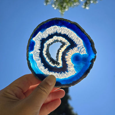 Agate Slice Set - Set of Six Blue Agate Crystal Coasters slice 5 backlit by sun