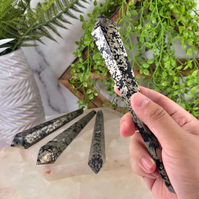 Pyrite Wands - You Choose variant D in hand for size reference with other variants in the background with props