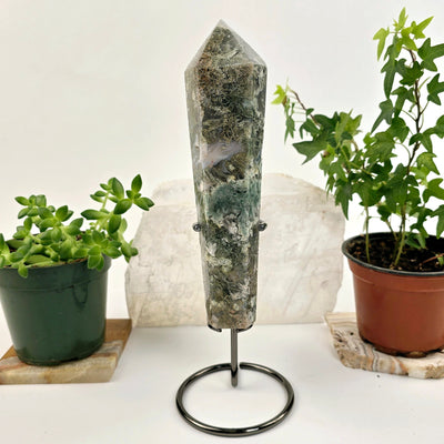 Moss Agate Wand on Stand 3 front view with plants and props in the background