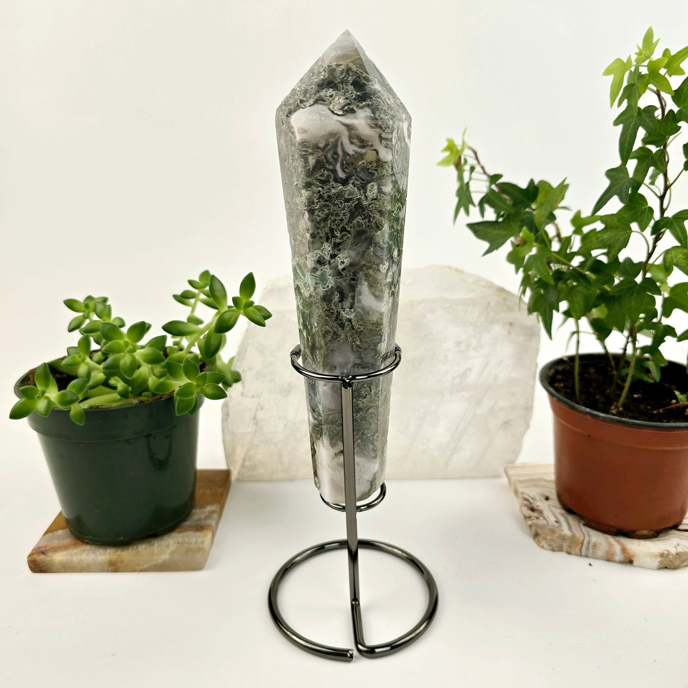 Moss Agate Wand on Stand 3 back view with plants and props in the background