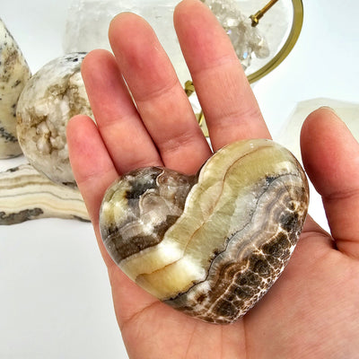 Mexican Onyx Heart 2 - in hand for size reference with props in the background