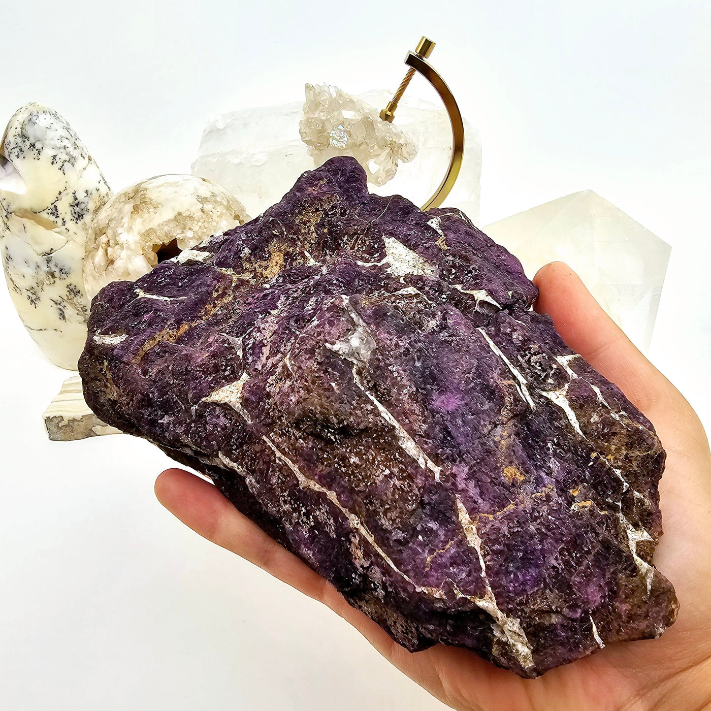 Purpurite - One-of-a-Kind in hand for size reference with props in the background