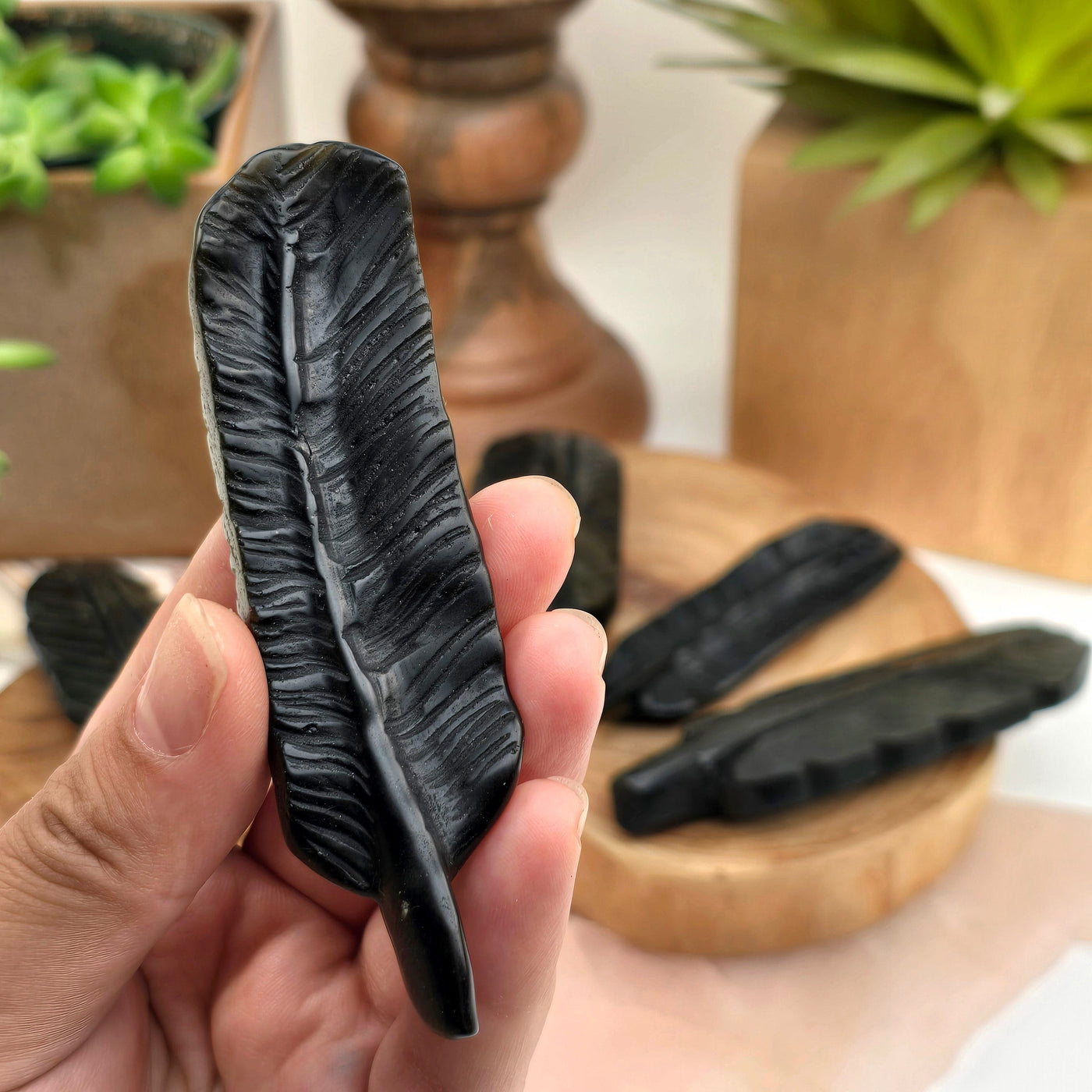 Gold Sheen Obsidian Feather - You Choose variant 2 in hand for size reference with other variants in background