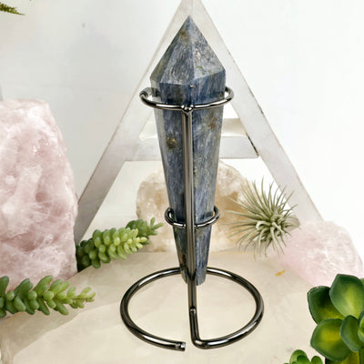 Blue Kyanite Crystal Wand on Stand #3 back view with props and plants in the background