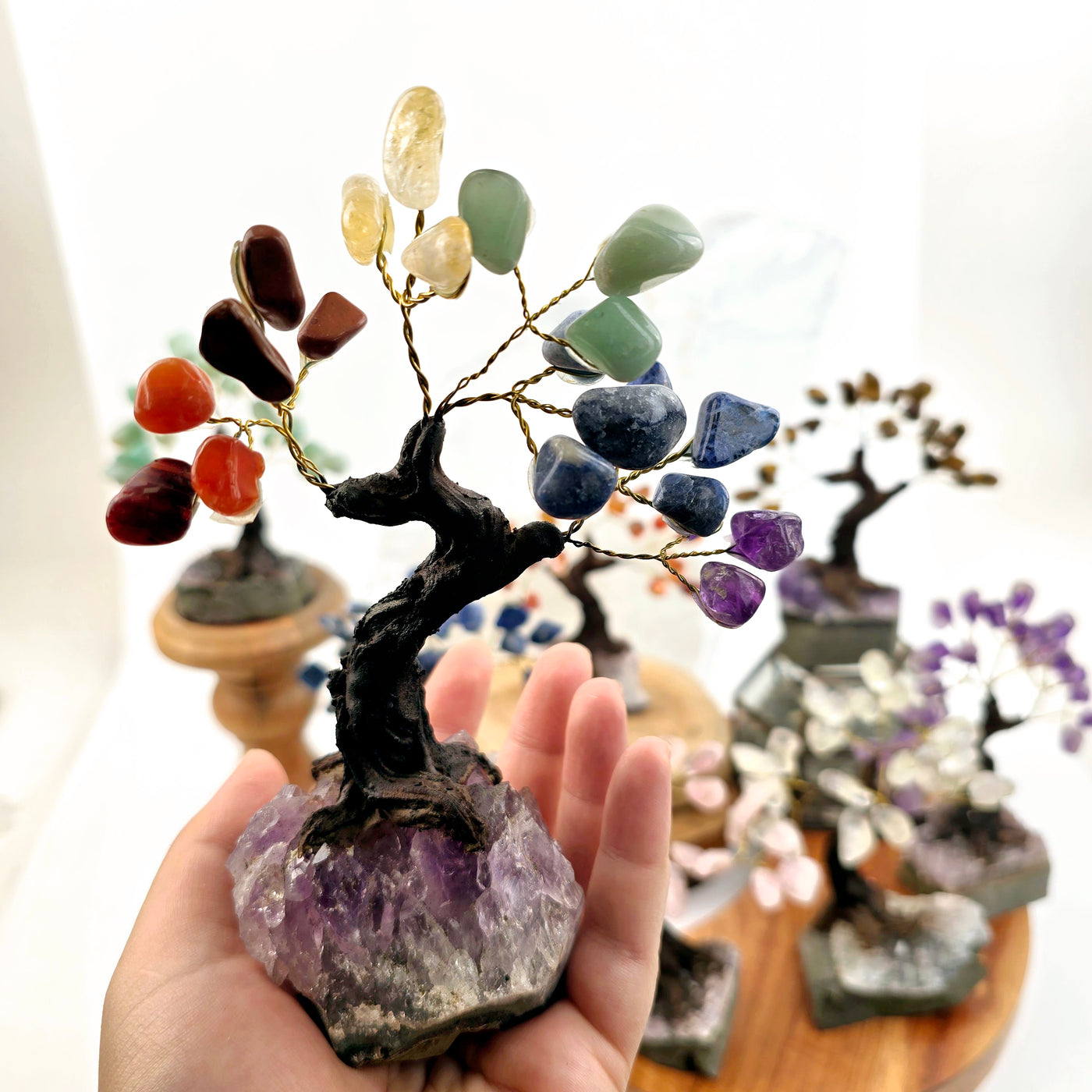 Tumbled Gemstone Tree with Amethyst Crystal Base - You Choose Stone - Chakra variant in hand for size reference with other variants in the background