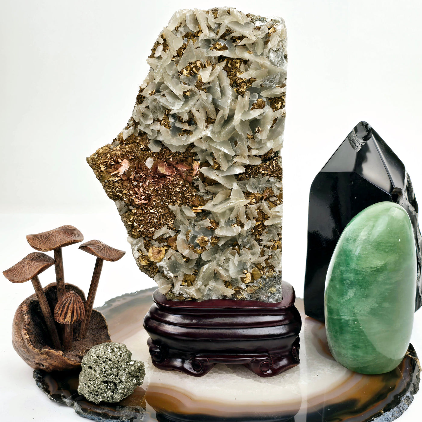 Pyrite and Calcite Crystal Cluster with Wooden Stand #1 front view with props in the background