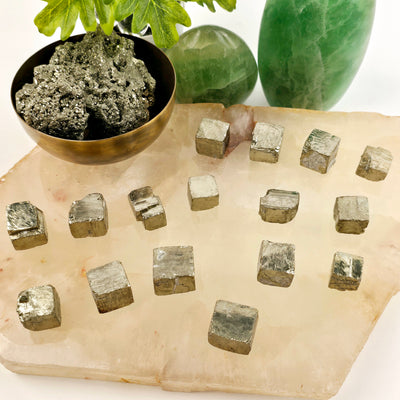 Pyrite Cube - You Choose all variants on quartz platter with props and plants in the background