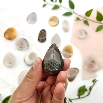 Natural Agate Druzy Cabochon - High Quality - You Choose - variant 12 in hand with other variants in the background for size reference