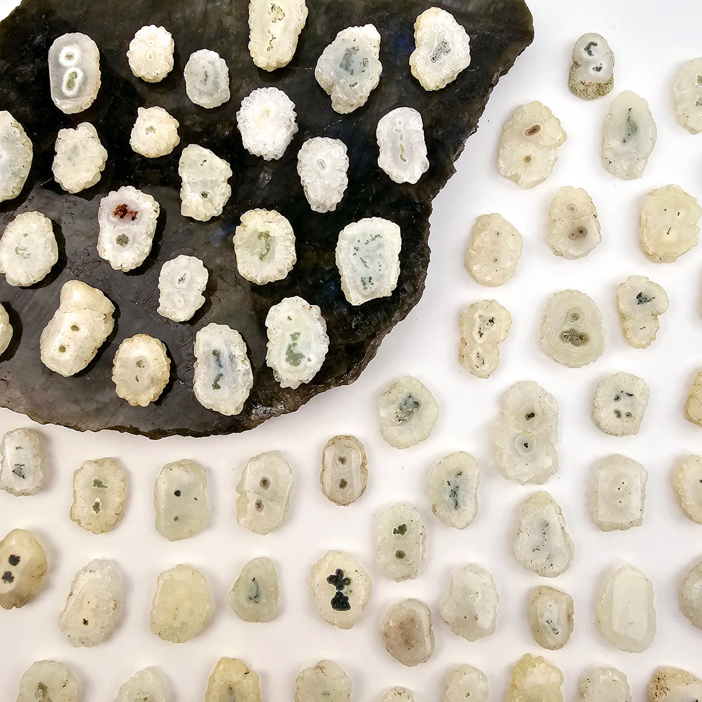 Crystal Stalactite Drilled Beads on stone platter and paper top view