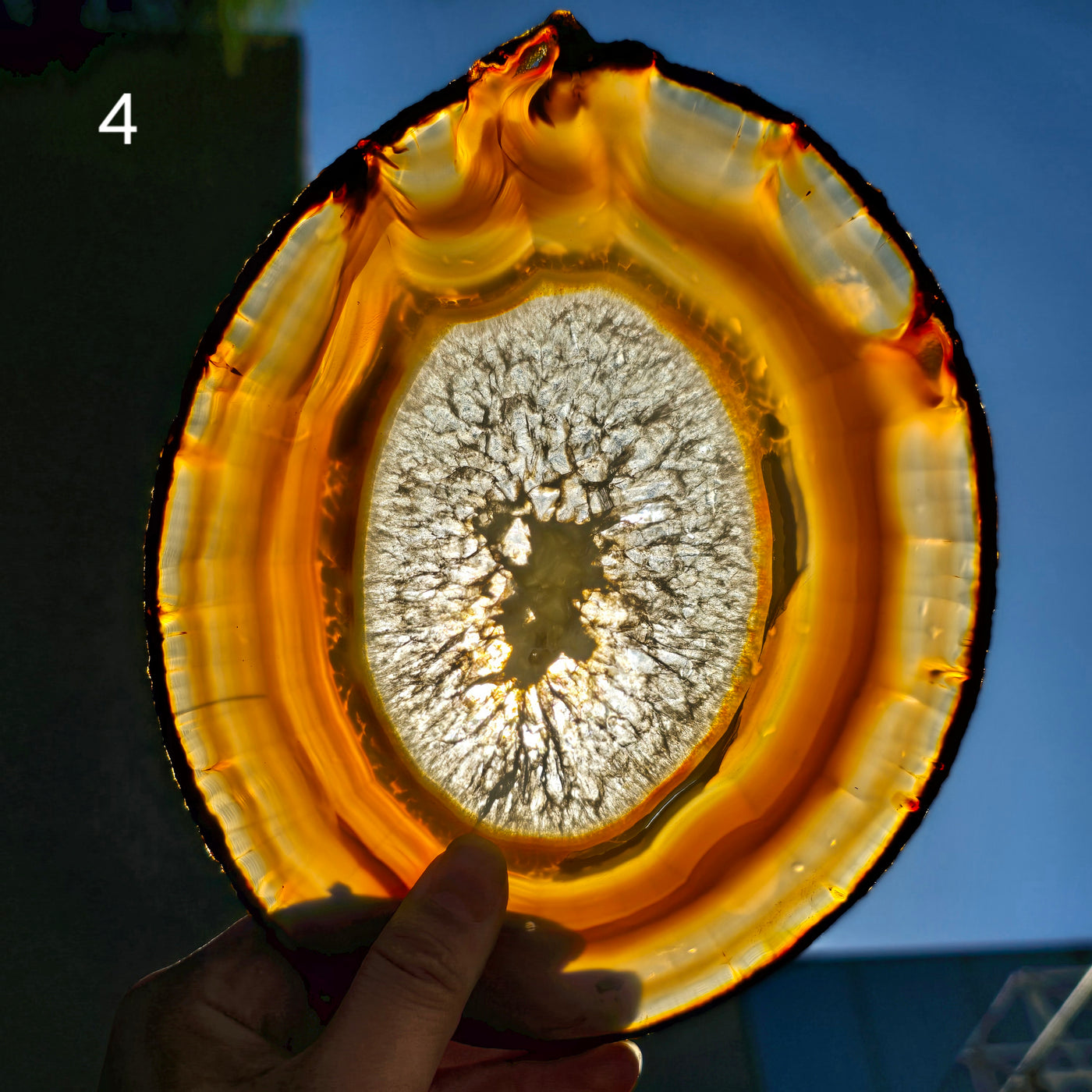 Iris Agate Crystal Slice - You Choose variant 4 backlit by sun