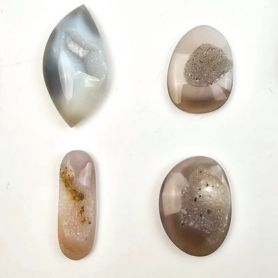 Natural Agate Druzy Cabochons - Lot of 16 - You Get All #3 - four cabochons of different shapes on white background