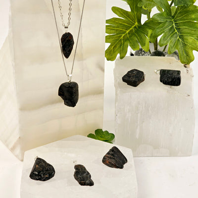 Black Tourmaline with Hematite Crystal Pendant - several pendants shown on selenite and Mexican Onyx