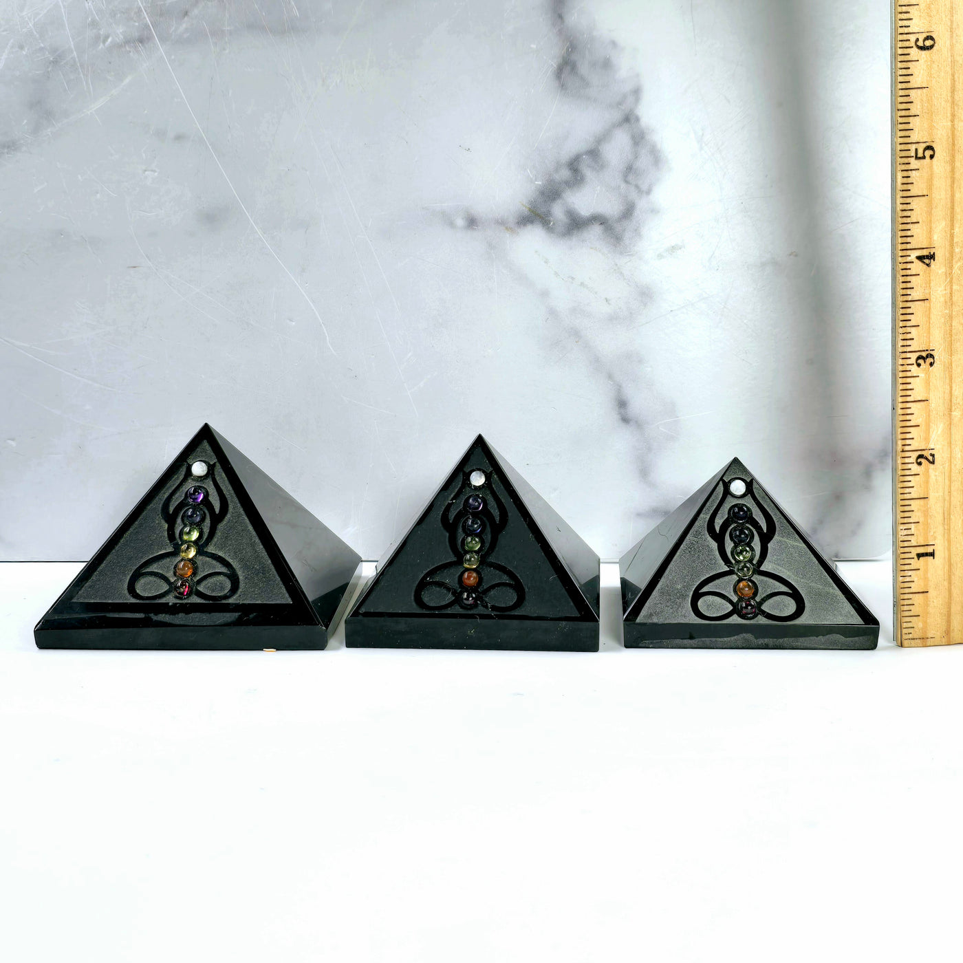 Black Obsidian Pyramid with Seven Chakra Crystal Accents three different sizes with ruler for size reference