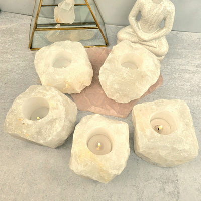 WHOLESALE Crystals - Case Pack Bulk Lot - By the Box - Crystal Quartz Candle Holder "B" Quality - SAVINGS with candles lit on gray background with props