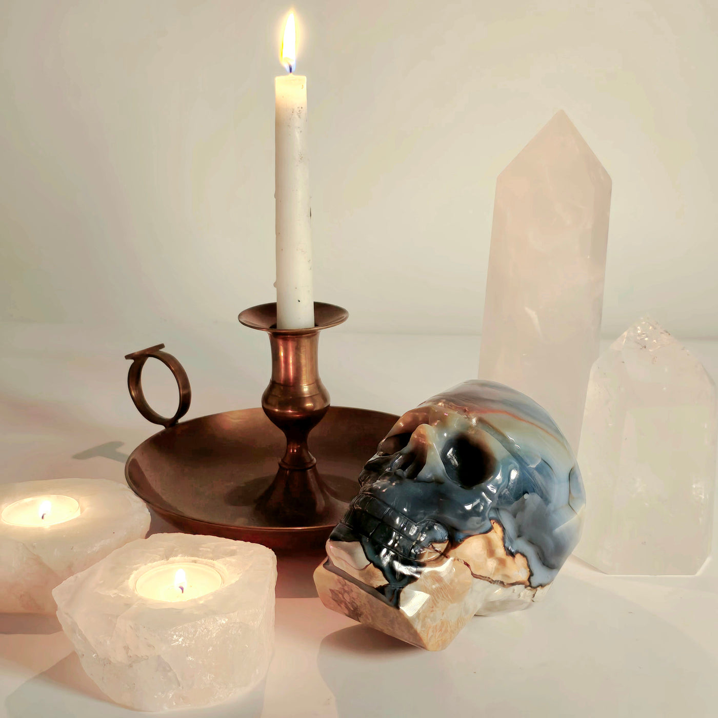 Lava Agate Crystal Skull Carving - One-of-a-Kind lifestyle shot with lit candles and crystal points