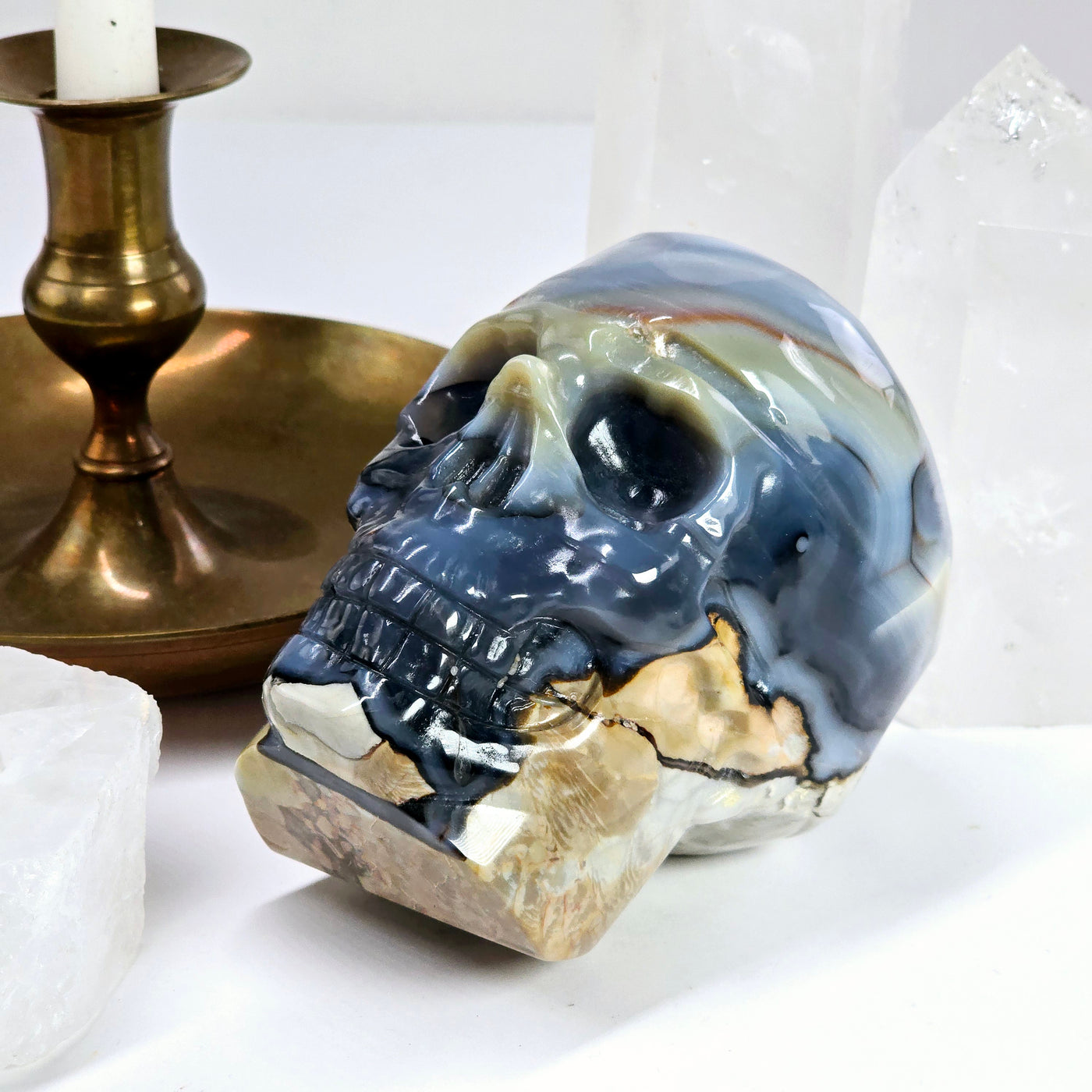 Lava Agate Crystal Skull Carving - One-of-a-Kind - 3/4 angle with props in the background