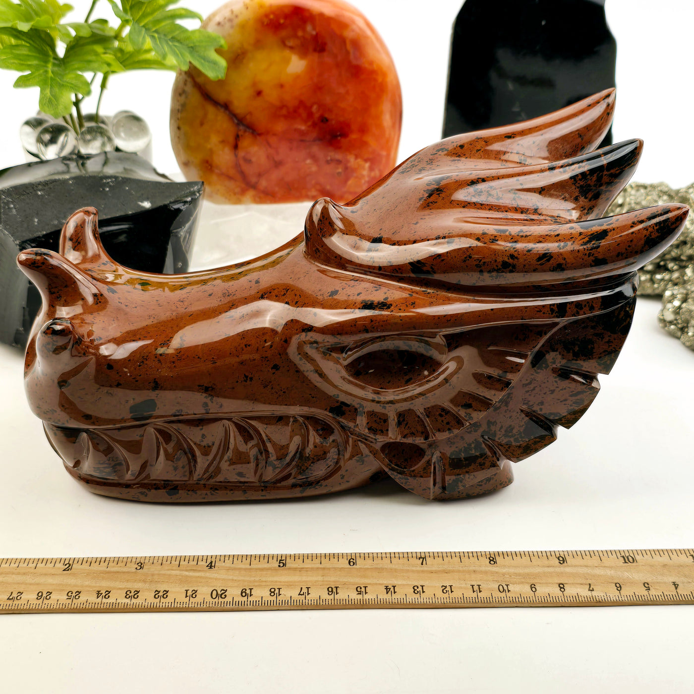 Mahogany Obsidian Crystal Dragon Head Carving with ruler for size reference