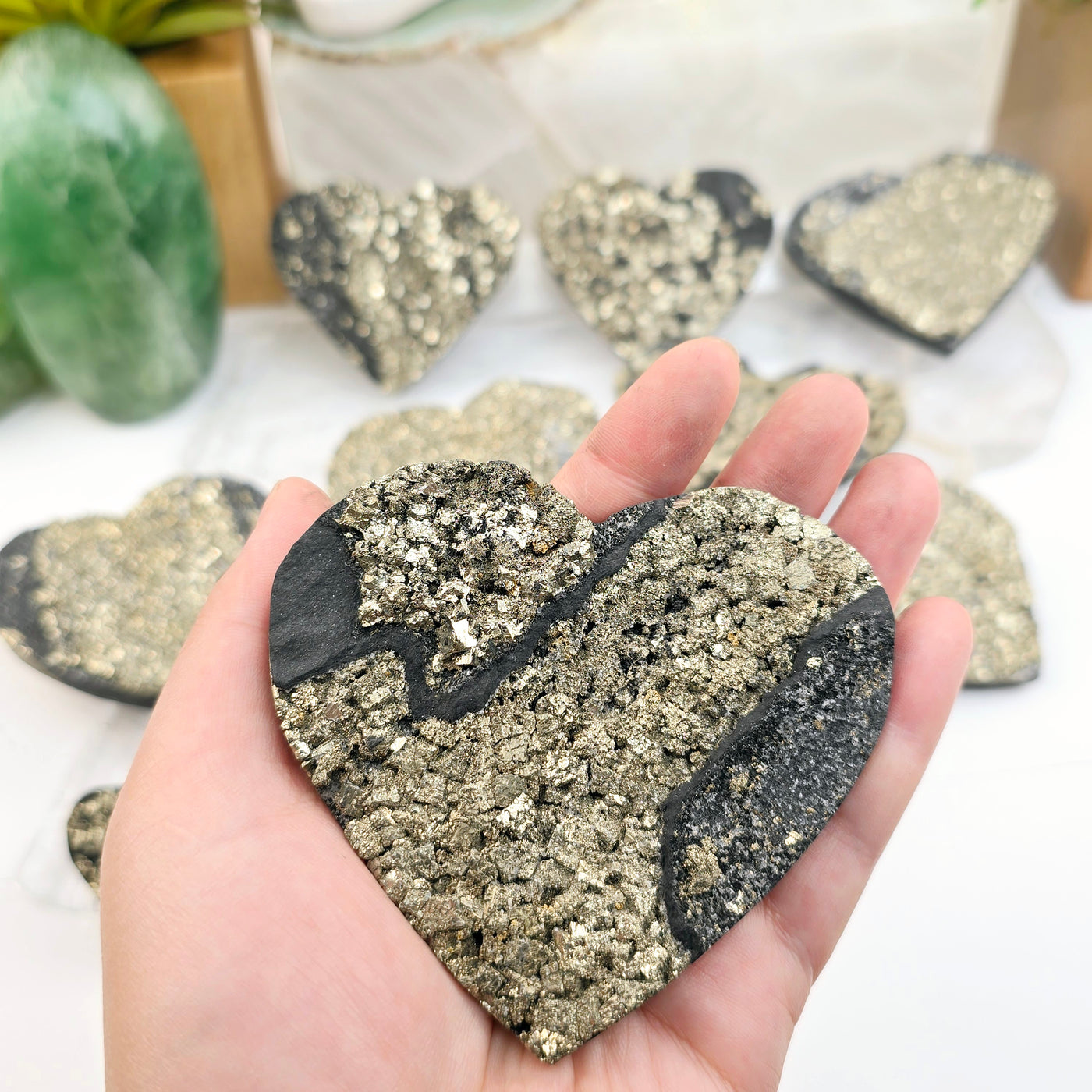 Pyrite on Basalt Crystal Heart - You Choose - variant 10 in hand for size reference with other variants in the background