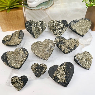 Pyrite on Basalt Crystal Heart - You Choose all variants on selenite platter with props and plants in the background