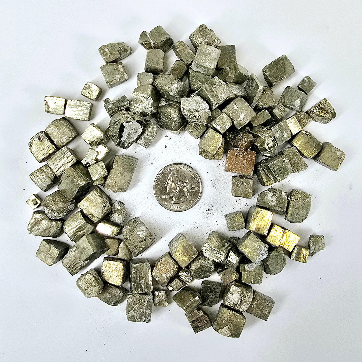 Pyrite Crystal Cubes - By the Pound surrounding quarter for size reference