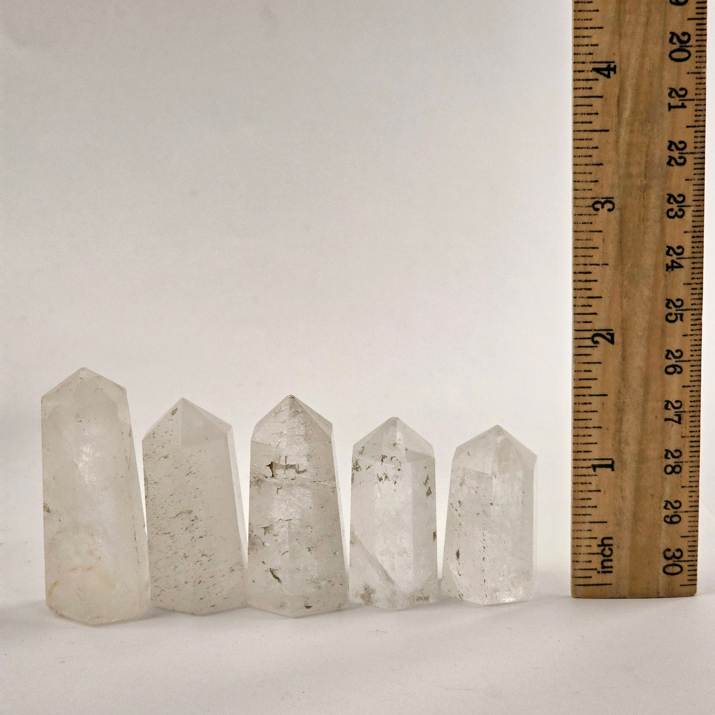 Crystal Quartz Small Obelisk Point five arranged in a row with ruler for size reference