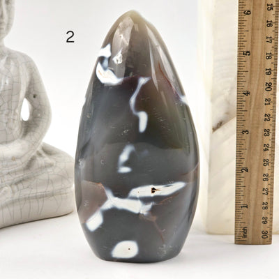 Orca Agate Polished Freeform Cut Base - You Choose variant 2 labeled with ruler for size reference next to Buddha statue