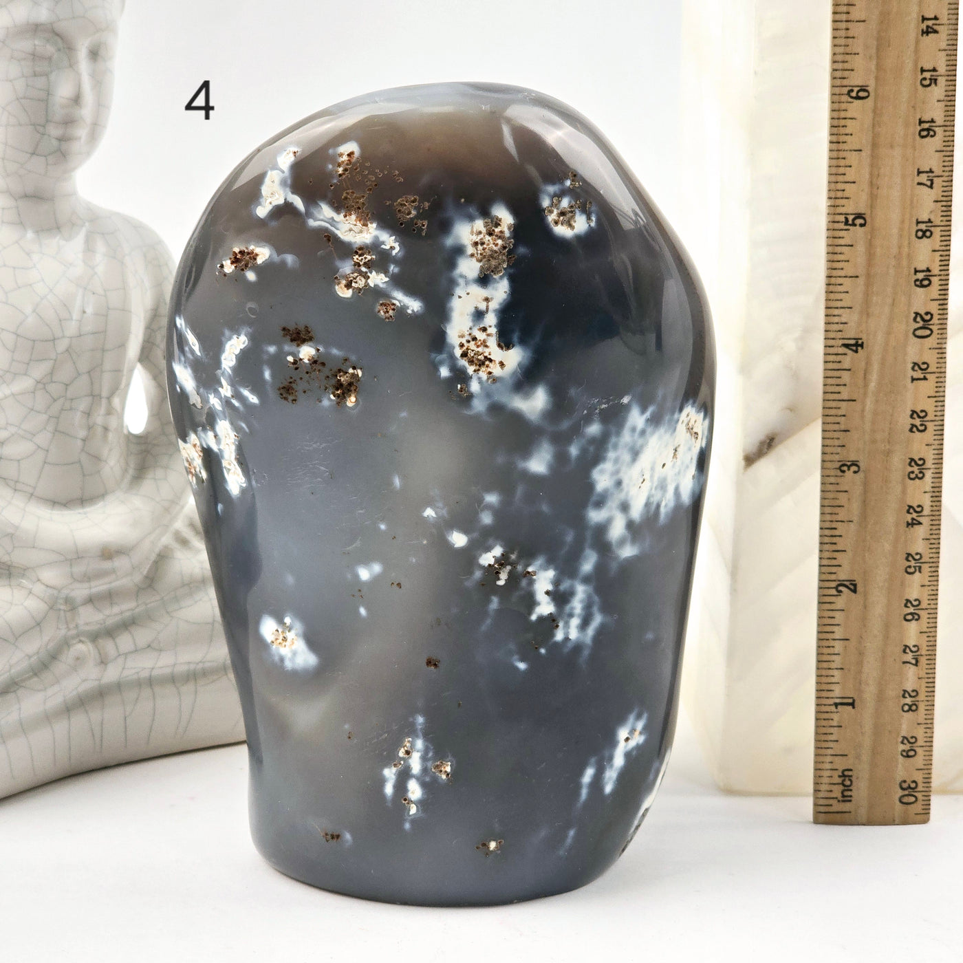 Orca Agate Polished Freeform Cut Base - You Choose variant 4 labeled with ruler for size reference next to Buddha statue