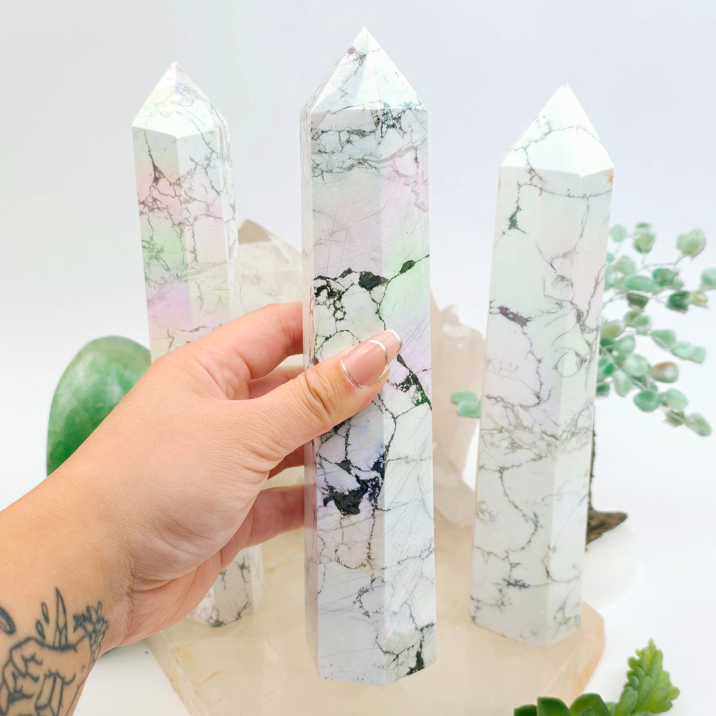 White Howlite Angel Aura Crystal Obelisk - You Choose - variant B in hand for size reference with other variants in the background