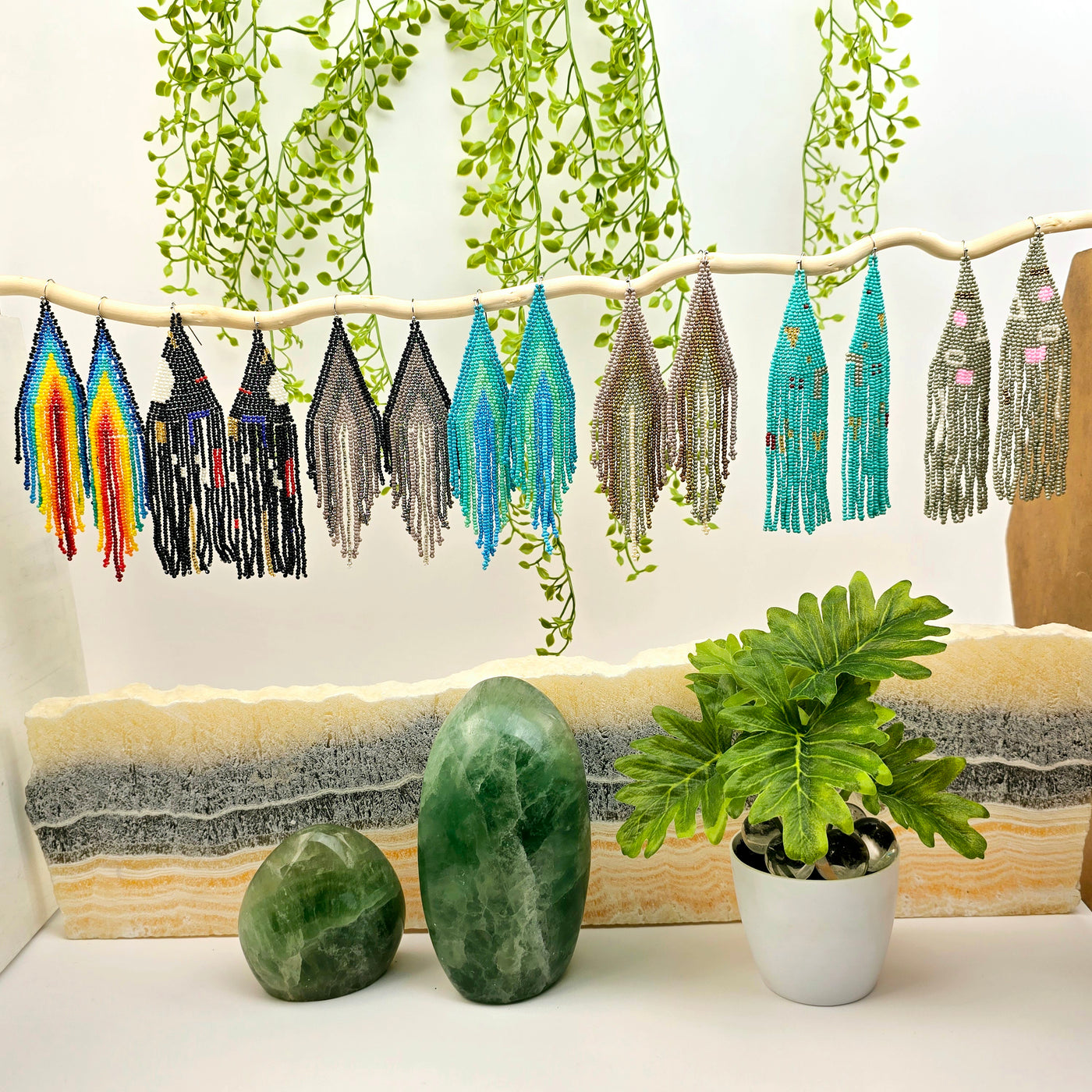 Seed Bead Earrings - Large Triangle and Fringe Pattern - You Choose Style - all variants on white branch with props and plants in the background