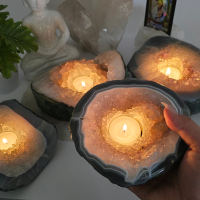 Crystal Geode Semi Polished Candle Holder - You Choose one in hand for size reference all with candles lit inside candle holders with props and plants in background