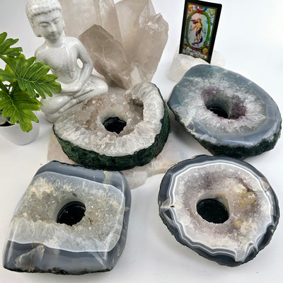 Crystal Geode Semi Polished Candle Holder - You Choose all variants no candles in bright lighting with props and plants in the background