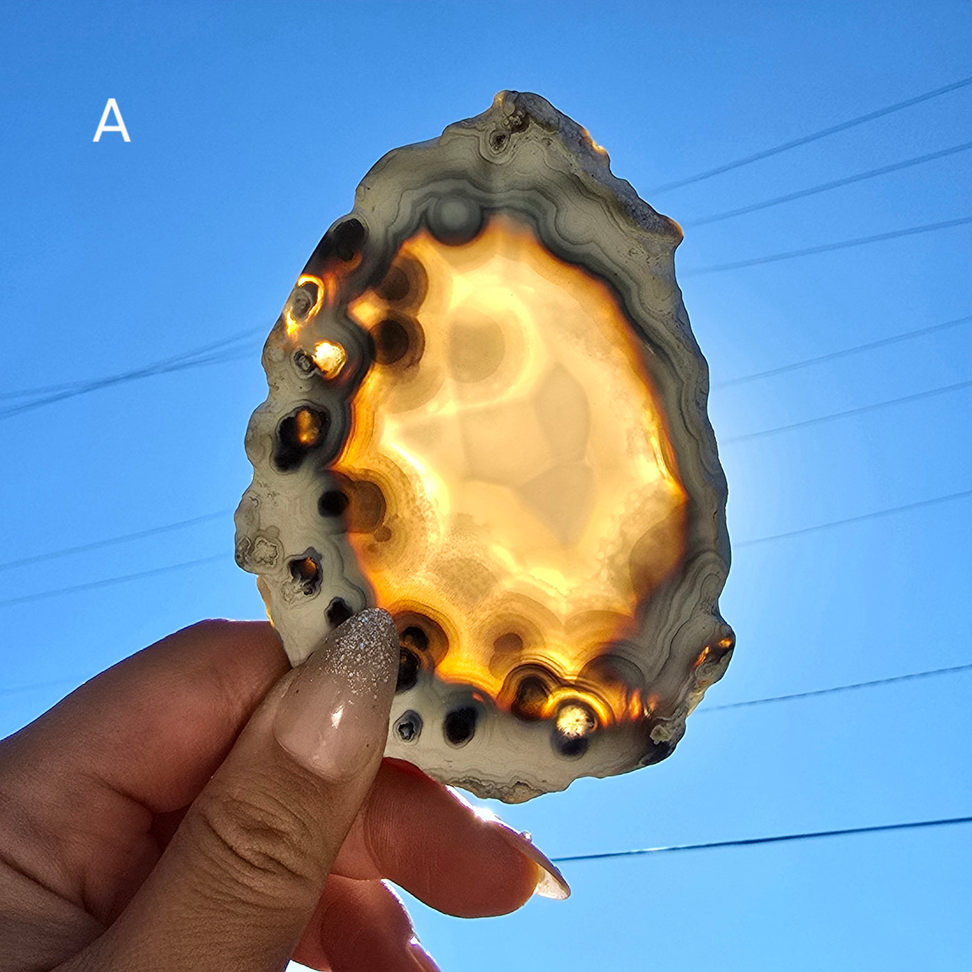 Agate Slice - Irregular Freeform Agate Crystal Slice - You Choose variant A backlit in hand for size reference