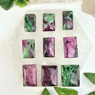 Ruby Zoisite - Anyolite - Crystal Rectangle Cabochon - You Choose all 9 variants on selenite platter with plants and props in the background