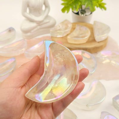 Angel Aura Crystal Quartz Moon Bowls - You Choose #1 one in hand for size reference with others in the background with props and plants