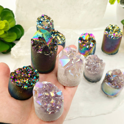 Amethyst Crystal Cluster Cylinder - Titanium Coated or Angel Aura - By Weight - You Choose Finish all four variants in hand with others in the background with props and plants
