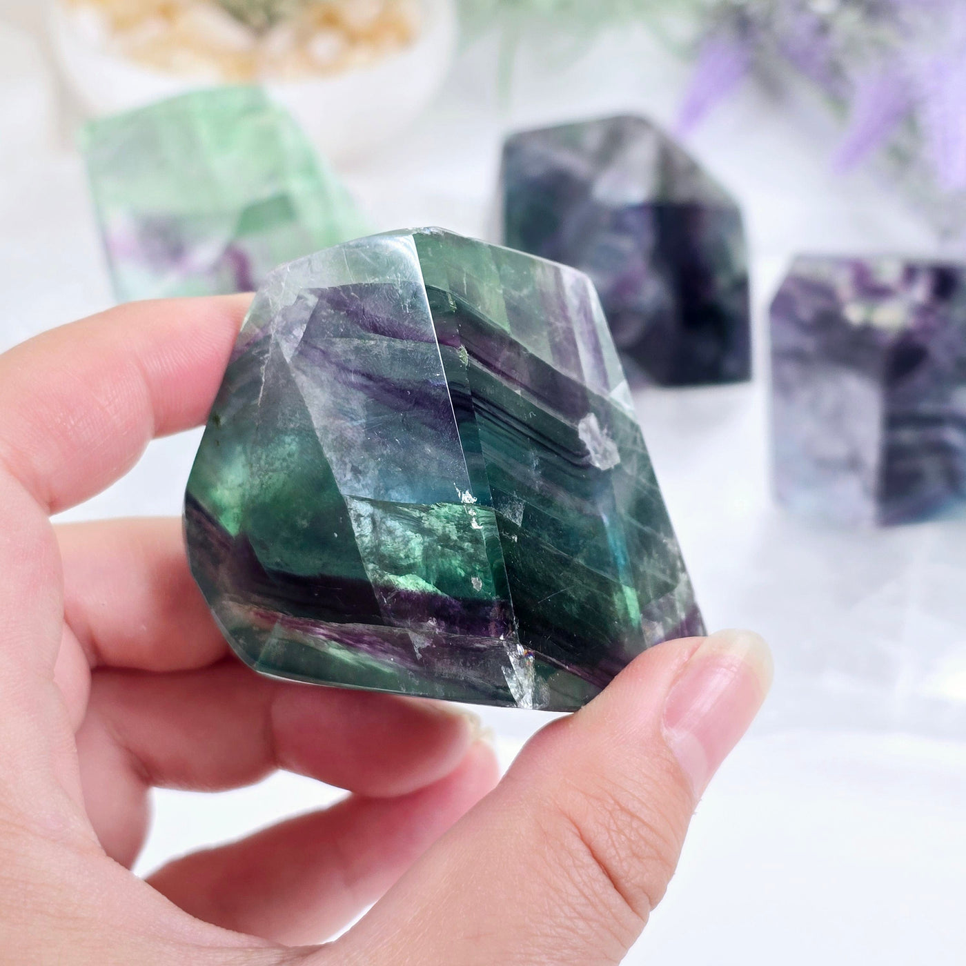 Rainbow Fluorite AA Grade Polished Crystal Freeform - You Choose variant 1 in hand for size reference with other variants in the background