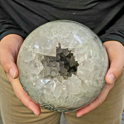 Light Amethyst Large Crystal Sphere One-of-a-Kind in hands for size reference