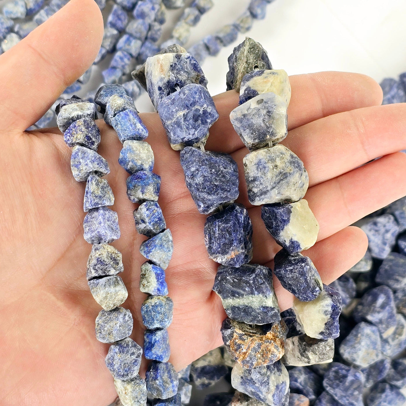 Rough Sodalite Crystal Beads - Full Strand - You Choose Size both sizes in hand for size reference with strands in the background