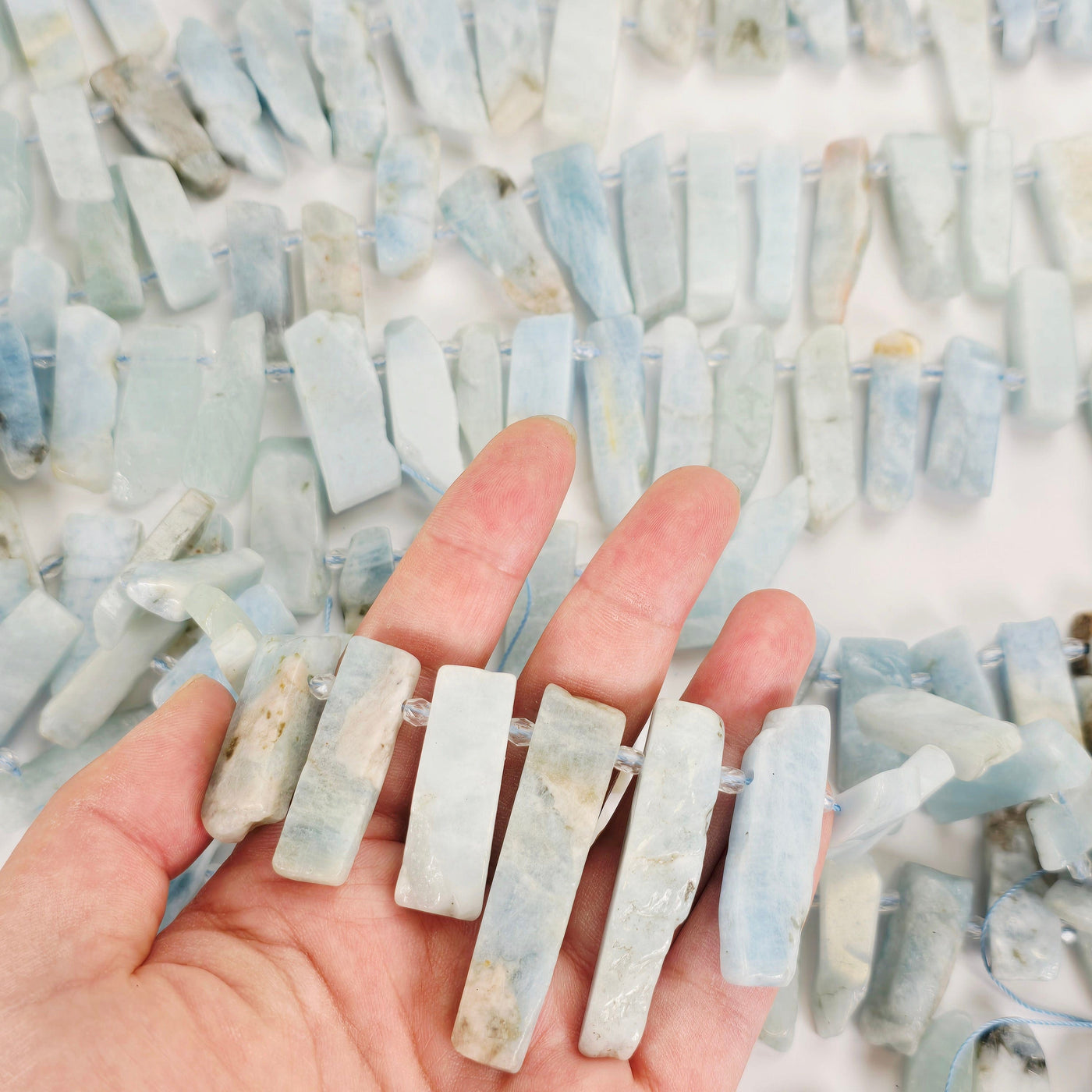 Aquamarine Polished Rectangular Crystal Shard Beads - Top Side Drilled - 1 Full Strand a few in hand with others in background