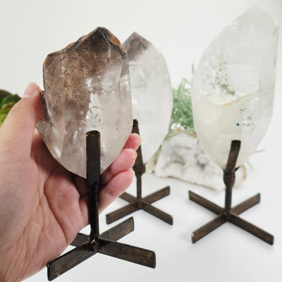 Polished Crystal Quartz with Inclusions on Metal Stand - You Choose variant 1 in hand for size reference with other variants in the background