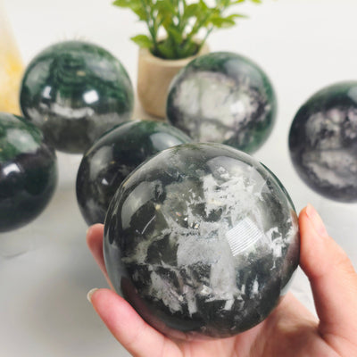 Fluorite Crystal Sphere - You Choose #2 one variant in hand with other variants in the background