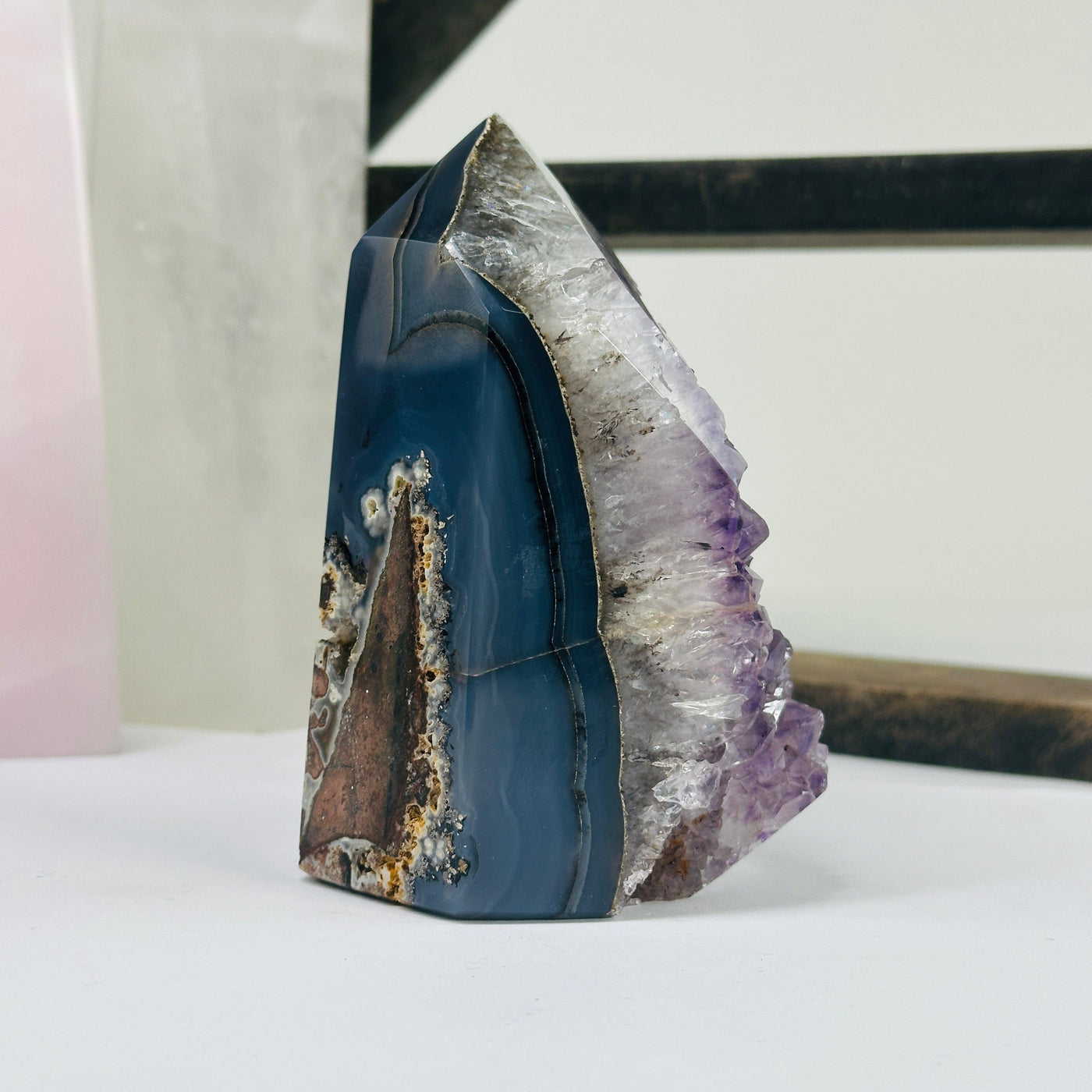 amethyst agate point with decorations in the background