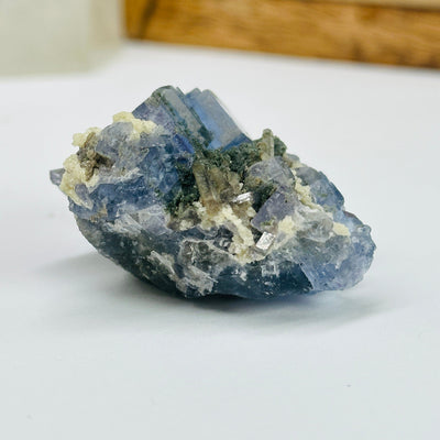 blue fluorite with decorations in the background