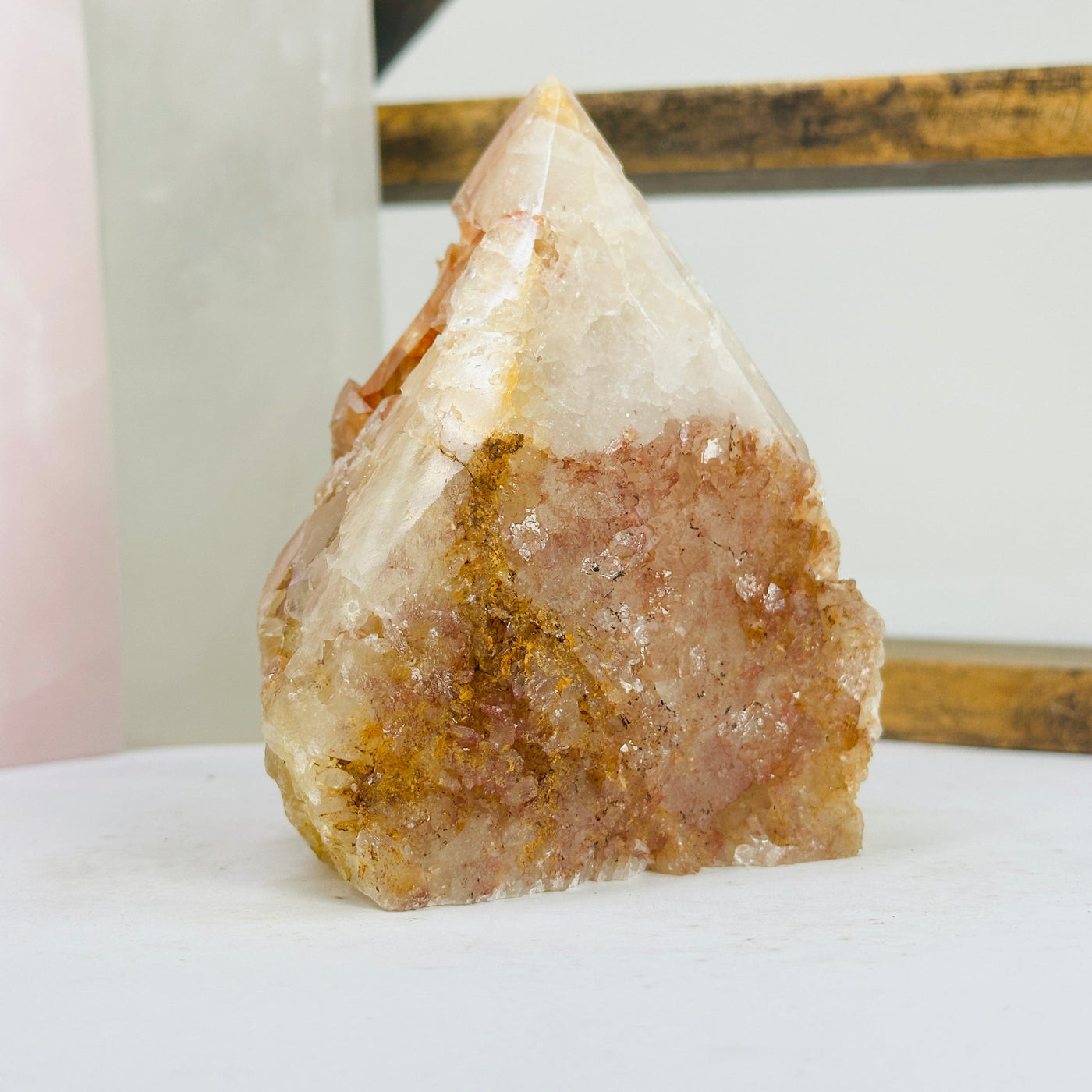 tangerine quartz points with decorations in the background