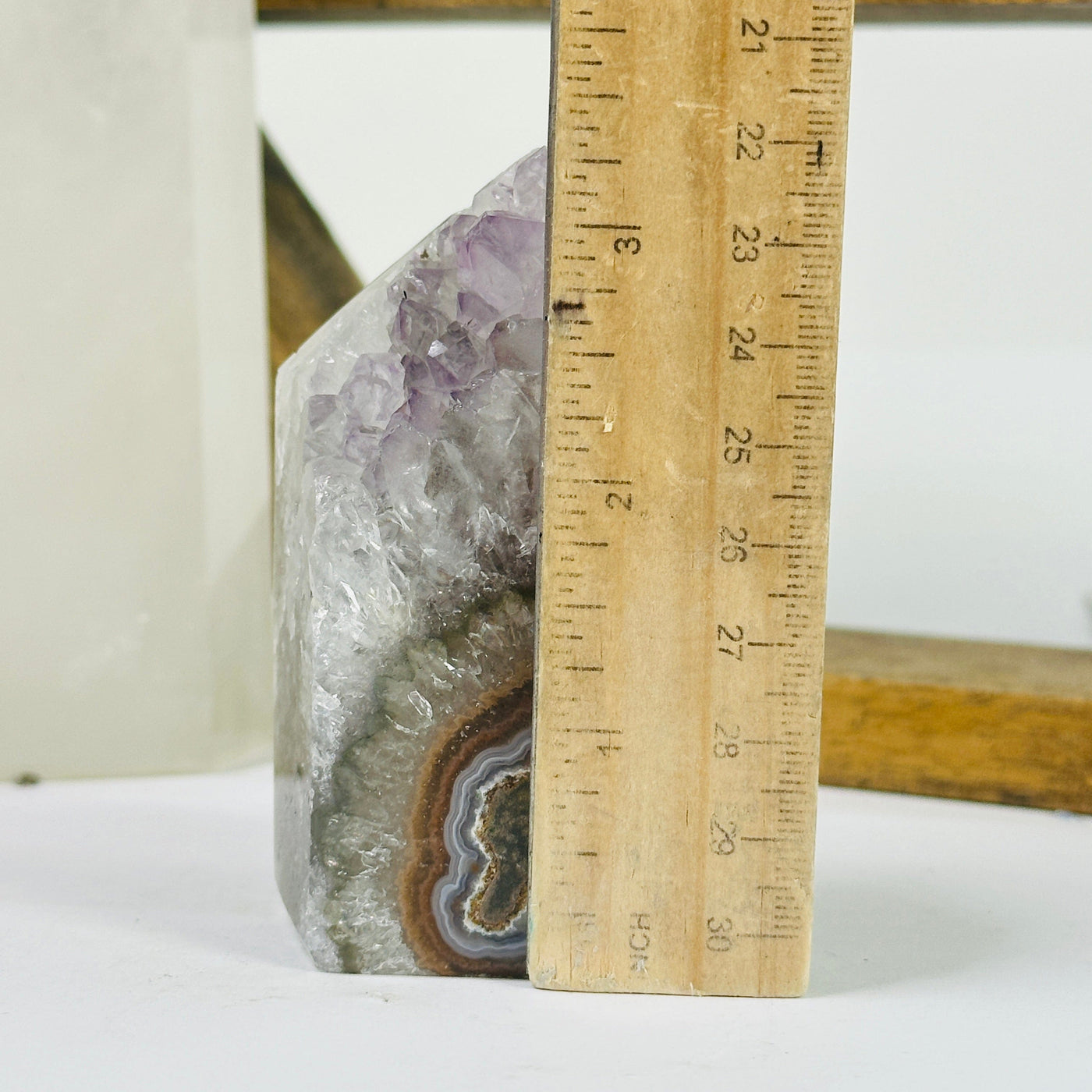 amethyst point next to a ruler for size reference